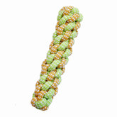 Braided dog toy with green and orange pattern on a white background